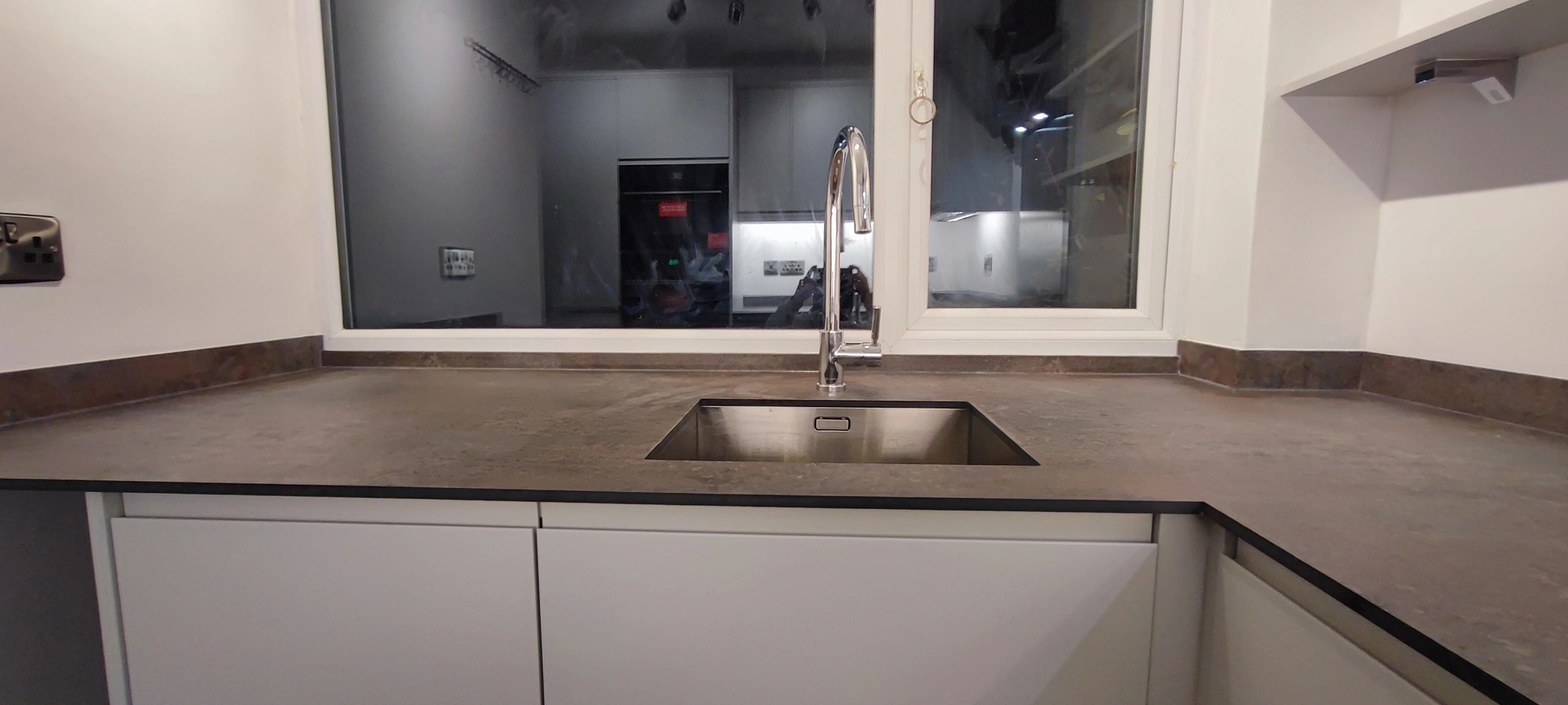 Sink run with a dark worktop and an undermount sink