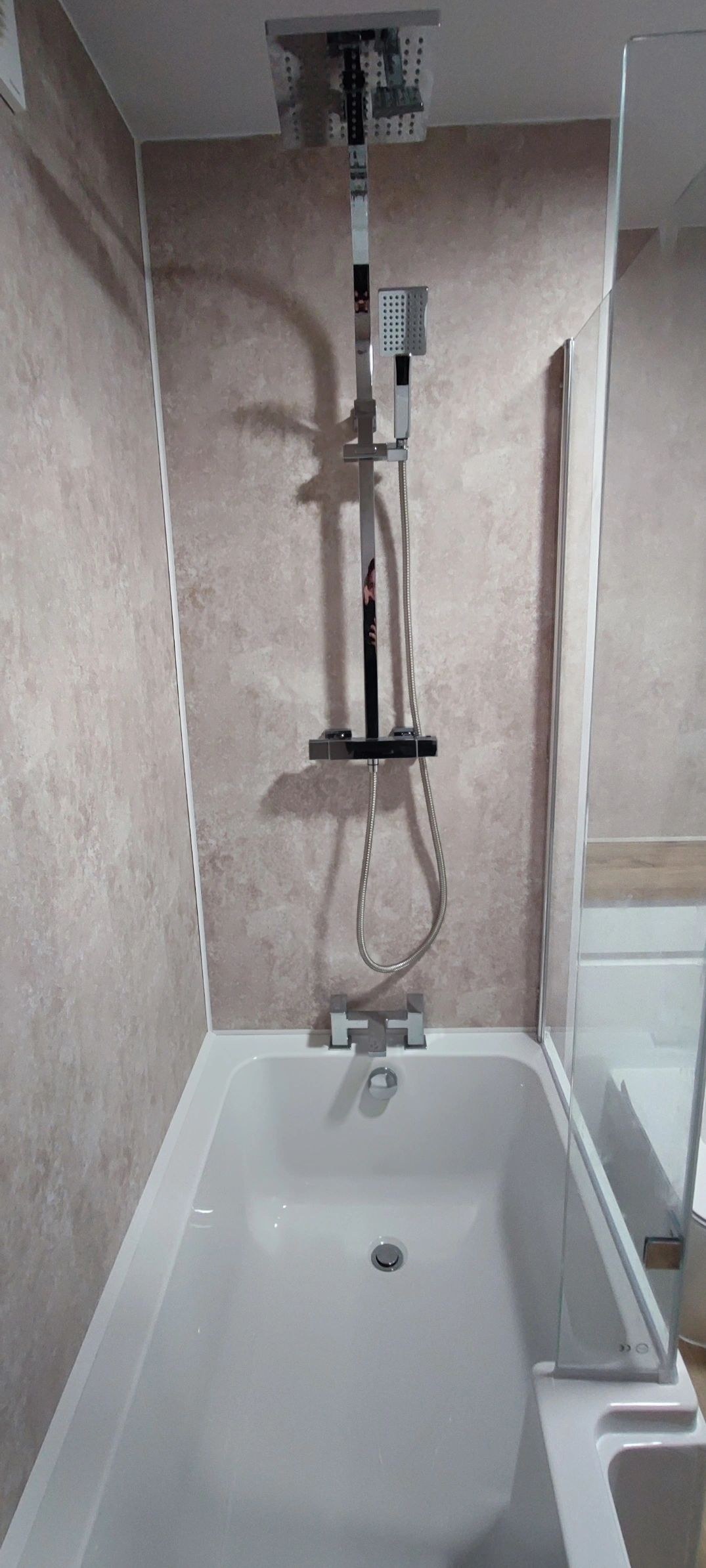 Bathroom with a shower bath and panelled walls